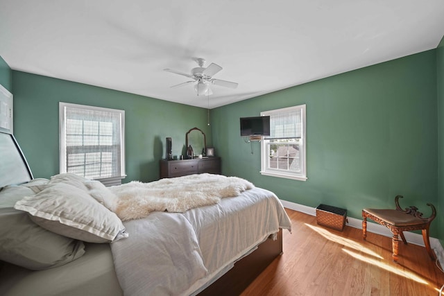 bedroom with ceiling fan and hardwood / wood-style flooring