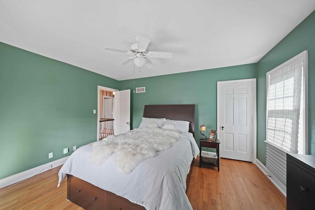 bedroom with light hardwood / wood-style floors and ceiling fan