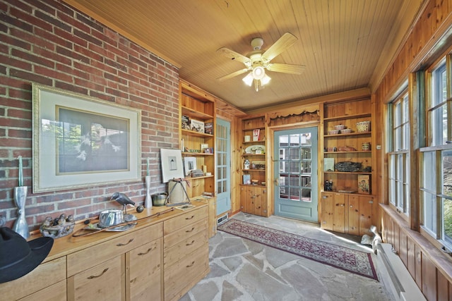 office area featuring ceiling fan, brick wall, built in features, and wood ceiling