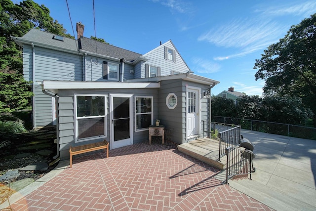 rear view of property featuring a patio area