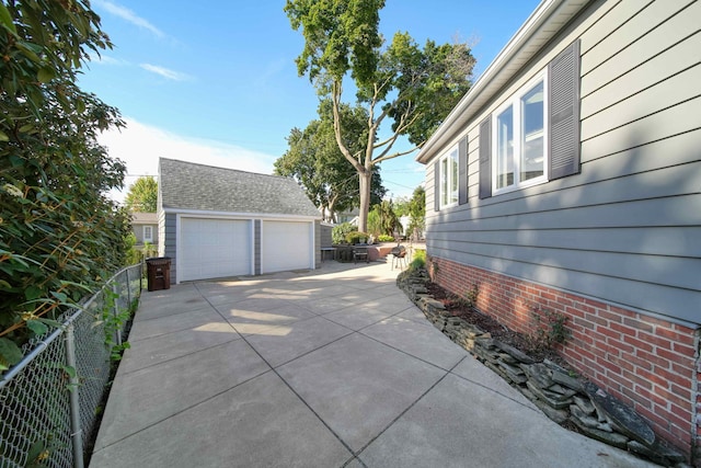 view of property exterior with a garage and an outdoor structure