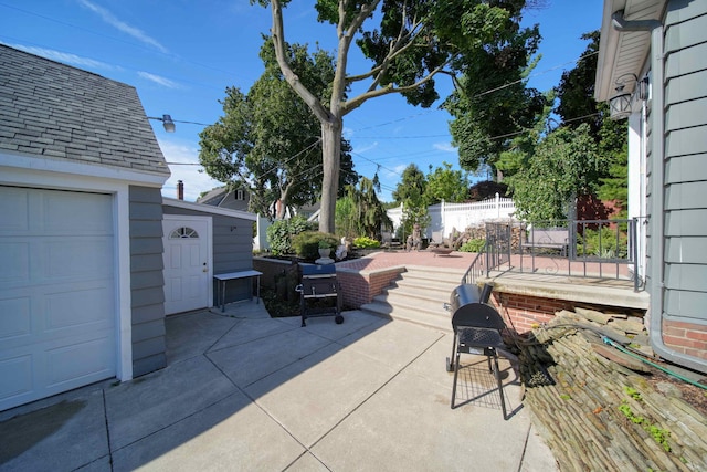 view of patio / terrace with an outbuilding and a garage