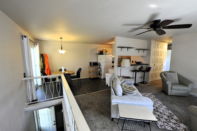 carpeted living room featuring ceiling fan