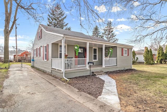 bungalow-style home featuring a front lawn and covered porch