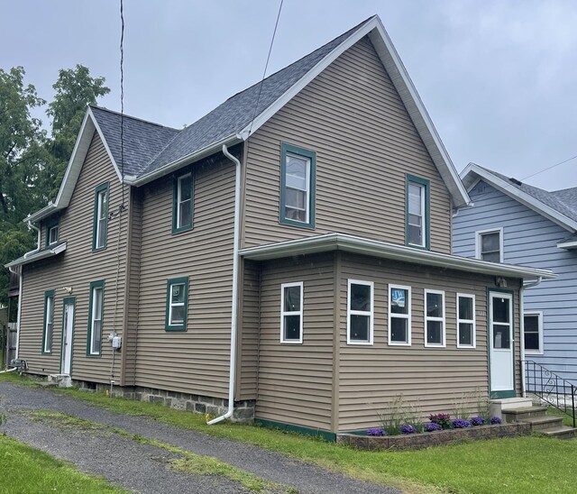 622 W Ganson St, Jackson, MI 49201 - view of home's exterior featuring entry steps and roof with shingles
