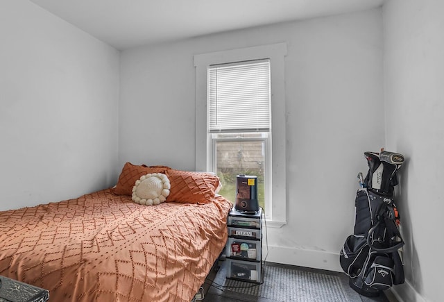 carpeted bedroom featuring multiple windows