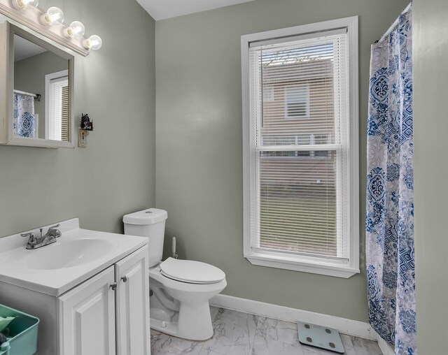 622 W Ganson St, Jackson, MI 49201 - full bathroom featuring marble finish floors, vanity, toilet, and baseboards