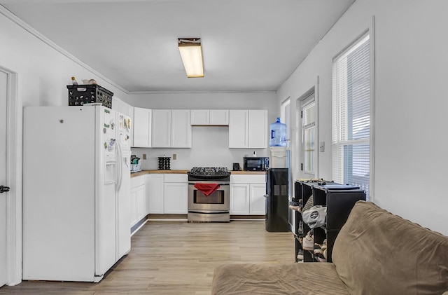 kitchen featuring white cabinetry, light hardwood / wood-style flooring, ornamental molding, and black appliances