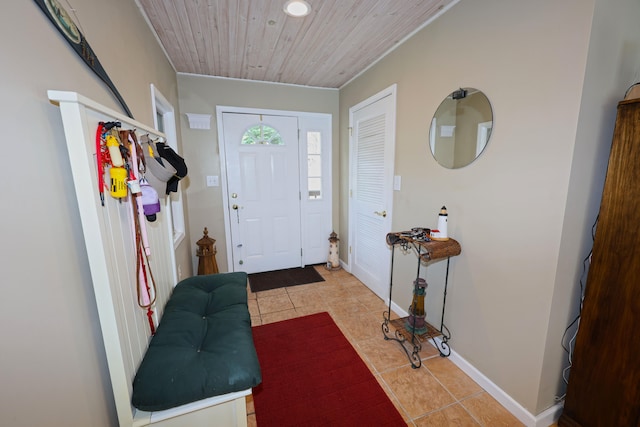 tiled entryway featuring wood ceiling