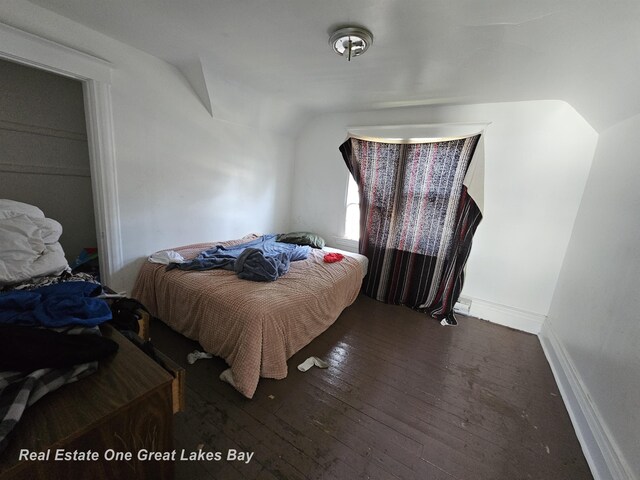 1209 S Fayette St, Saginaw, MI 48602 - bedroom with lofted ceiling, wood-type flooring, and baseboards
