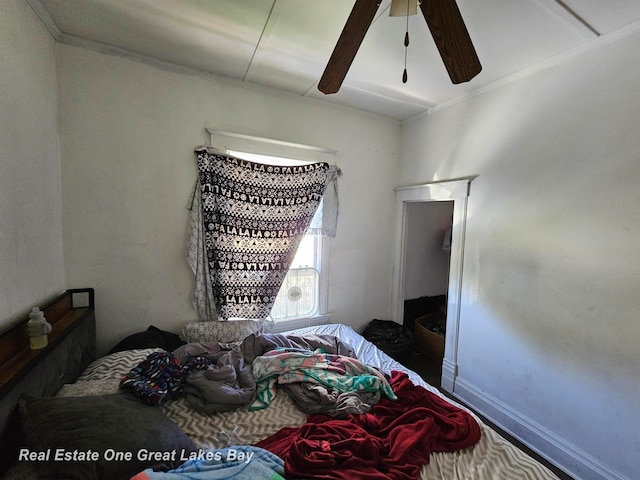 bedroom with ceiling fan and ornamental molding