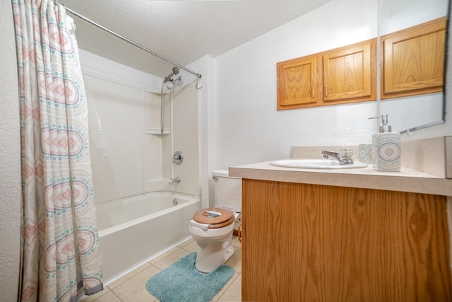 full bathroom featuring vanity, tile patterned flooring, toilet, shower / bath combo with shower curtain, and a textured ceiling