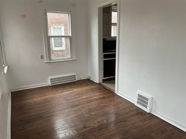 empty room featuring dark hardwood / wood-style flooring