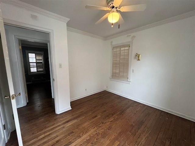 empty room with ornamental molding, ceiling fan, and dark hardwood / wood-style flooring