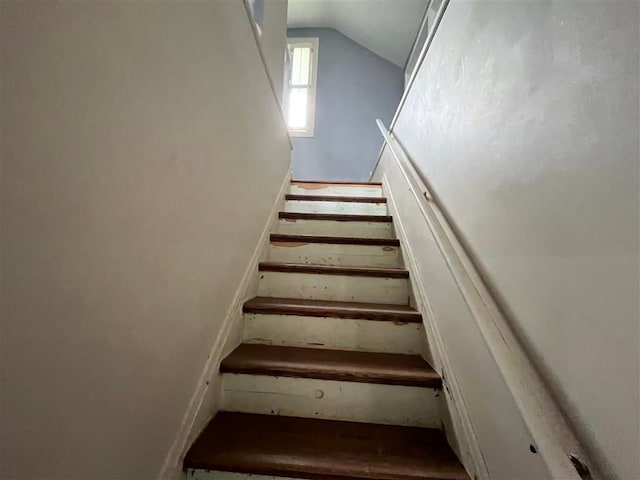 staircase featuring vaulted ceiling