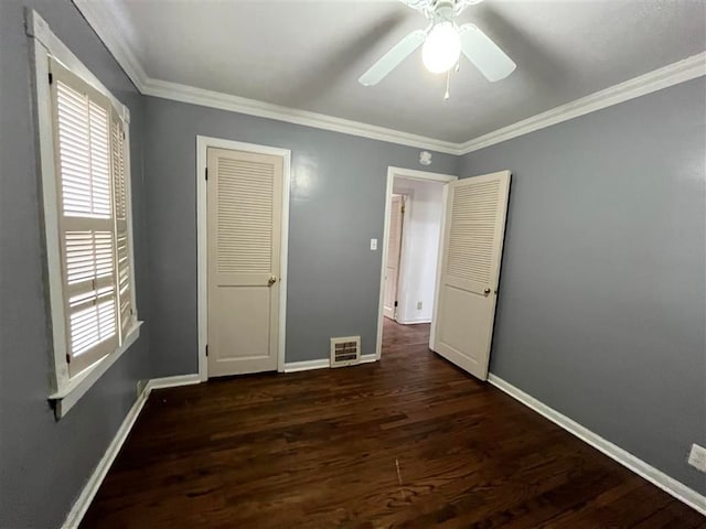 unfurnished bedroom featuring ceiling fan, ornamental molding, and dark hardwood / wood-style flooring