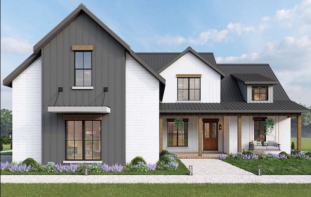 modern farmhouse style home with a porch and a front lawn