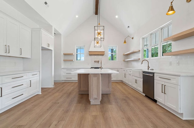 kitchen featuring stainless steel dishwasher, light wood-type flooring, and white cabinetry