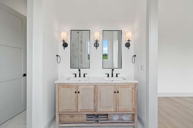 bathroom with vanity and wood-type flooring