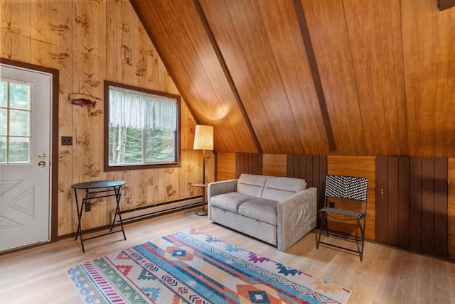 living area with vaulted ceiling with beams, wood walls, a baseboard radiator, and hardwood / wood-style flooring