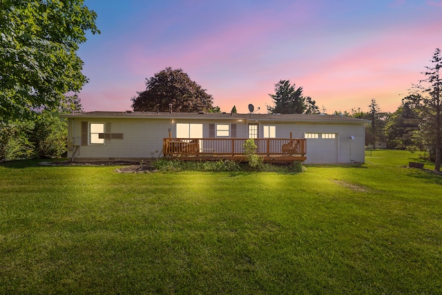 back house at dusk with a yard and a wooden deck