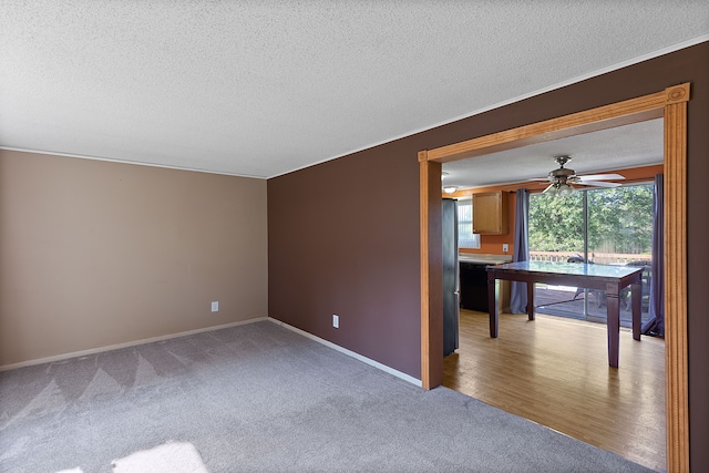 spare room featuring hardwood / wood-style floors, a textured ceiling, ceiling fan, and crown molding