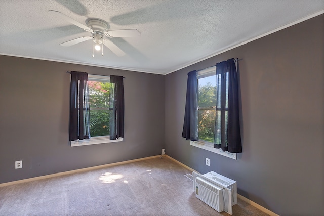 spare room featuring ceiling fan, ornamental molding, a textured ceiling, a wall mounted AC, and carpet floors