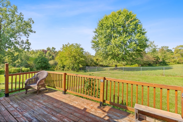 wooden deck featuring a lawn