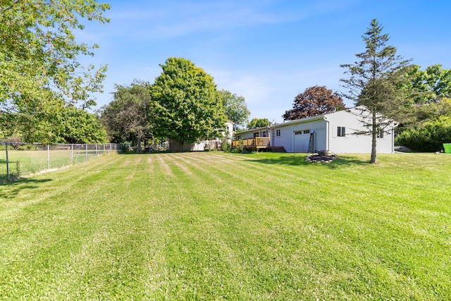 view of yard with a deck and a garage