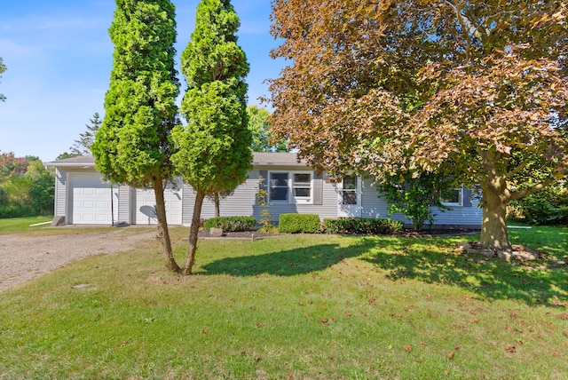 obstructed view of property with a front yard and a garage