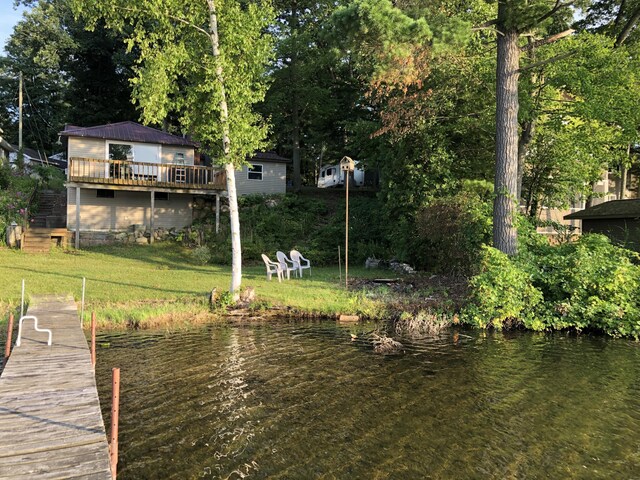589 E Sidney Rd, Stanton, MI 48888 - dock area with a deck with water view and a lawn