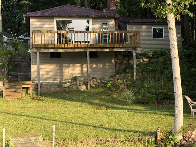 589 E Sidney Rd, Stanton, MI 48888 - back of house featuring stairway, a wooden deck, a yard, and metal roof