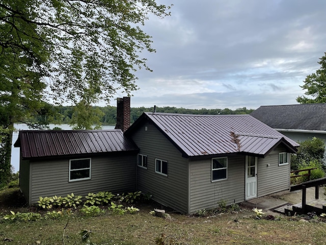 589 E Sidney Rd, Stanton, MI 48888 - rear view of house with a chimney and a metal roof