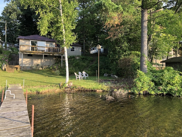 589 E Sidney Rd, Stanton, MI 48888 - dock area with a deck with water view and a lawn