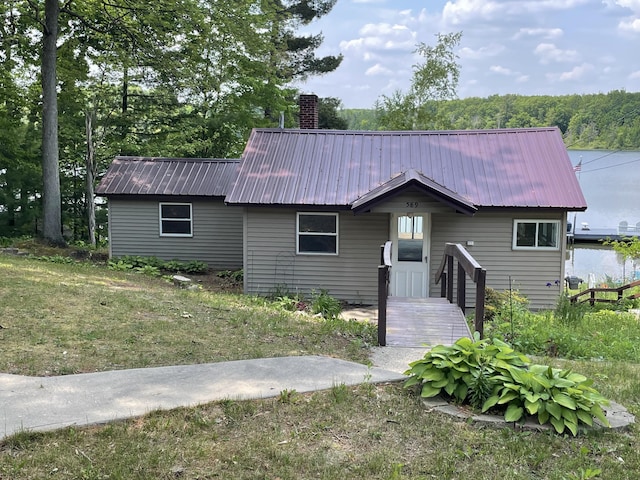 589 E Sidney Rd, Stanton, MI 48888 - ranch-style home featuring a metal roof and a chimney