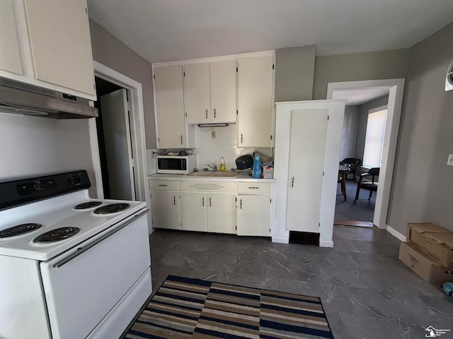 kitchen featuring sink, white cabinets, and white appliances