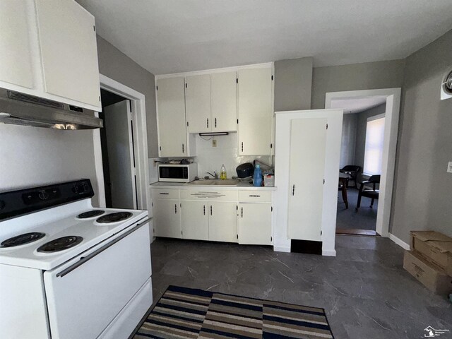 kitchen with sink, white cabinets, and white appliances