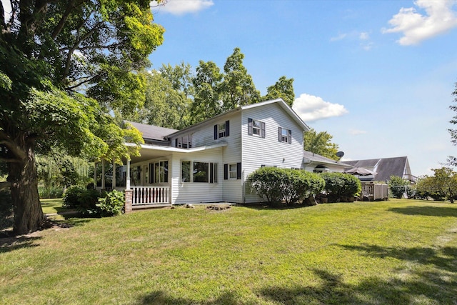 rear view of property featuring a yard