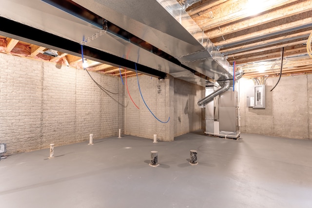 basement with electric panel and heating unit