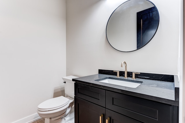 bathroom featuring hardwood / wood-style floors, vanity, and toilet