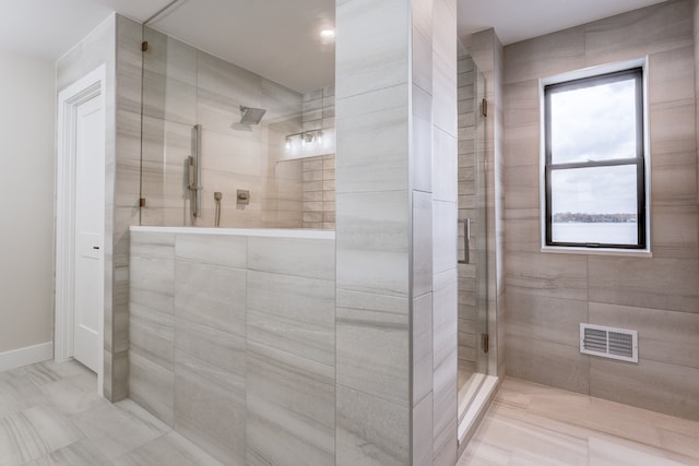 bathroom with a tile shower