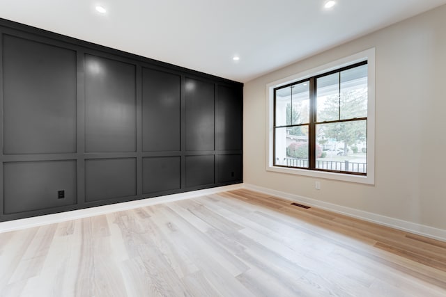 unfurnished room with light wood-type flooring