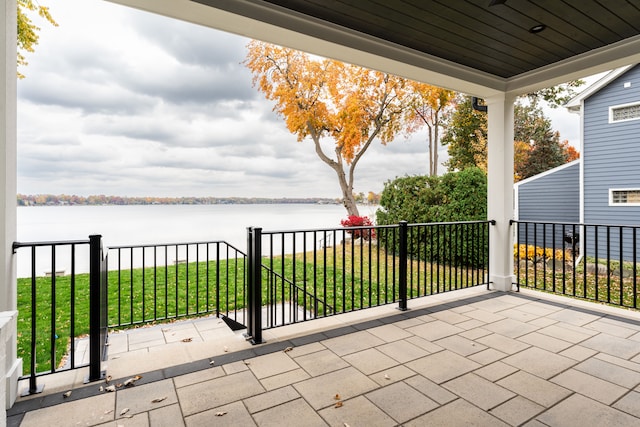 view of patio / terrace featuring covered porch and a water view