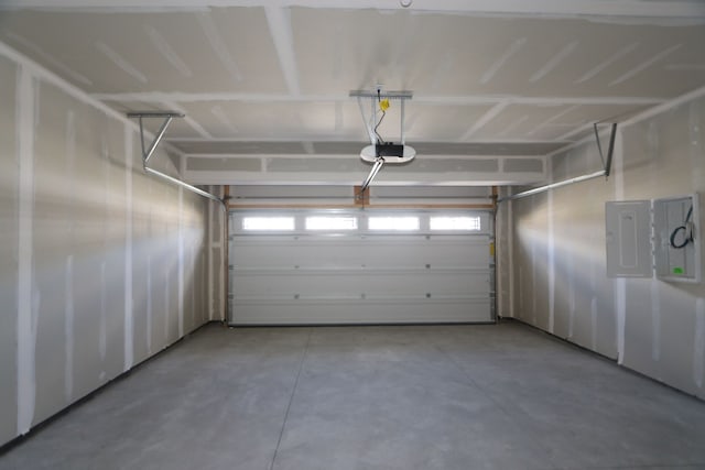 garage with electric panel and a garage door opener