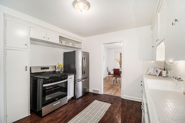 kitchen featuring white cabinetry, sink, appliances with stainless steel finishes, and dark wood-type flooring