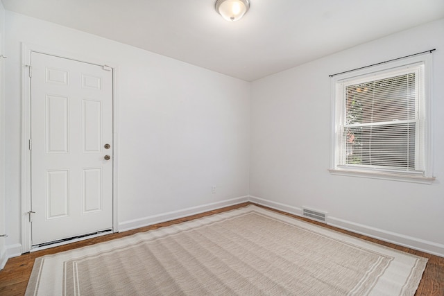 unfurnished room with dark hardwood / wood-style floors