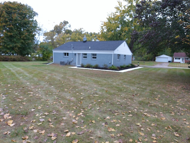 exterior space with a garage and a lawn