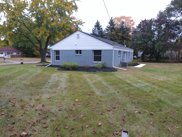 view of property exterior featuring a yard and central AC unit