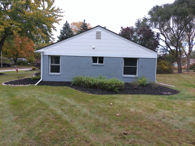 view of property exterior with a yard