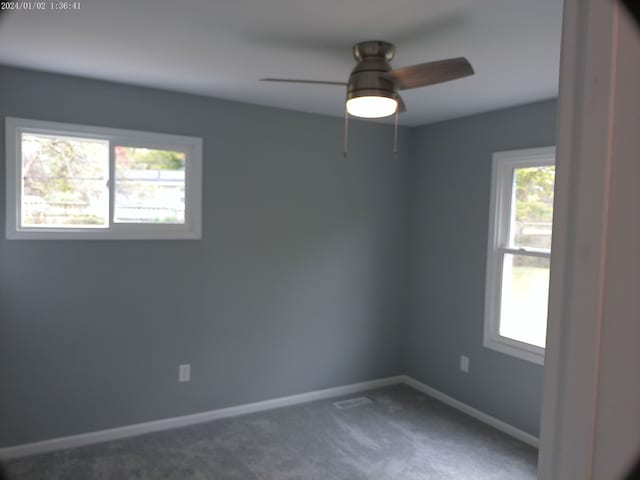 carpeted empty room featuring ceiling fan